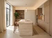 Establishing shot of a Warm Minimalism kitchen with a rounded travertine island, bleached walnut cabinets, and linen drapes.