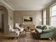 Living room with a teal sofa and two beige armchairs around a glass coffee table, framed landscape art above a wood credenza