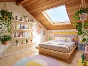 Attic bedroom with a wood sloped ceiling, a skylight, macrame hanging plants, and shelves of colorful ceramic vases