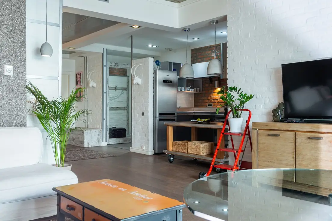 A warm apartment living room and kitchen, the kind of rental space a room divider needs to work within
