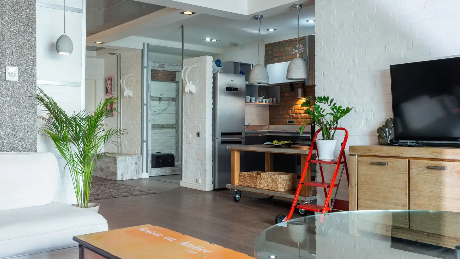 A warm apartment living room and kitchen, the kind of rental space a room divider needs to work within