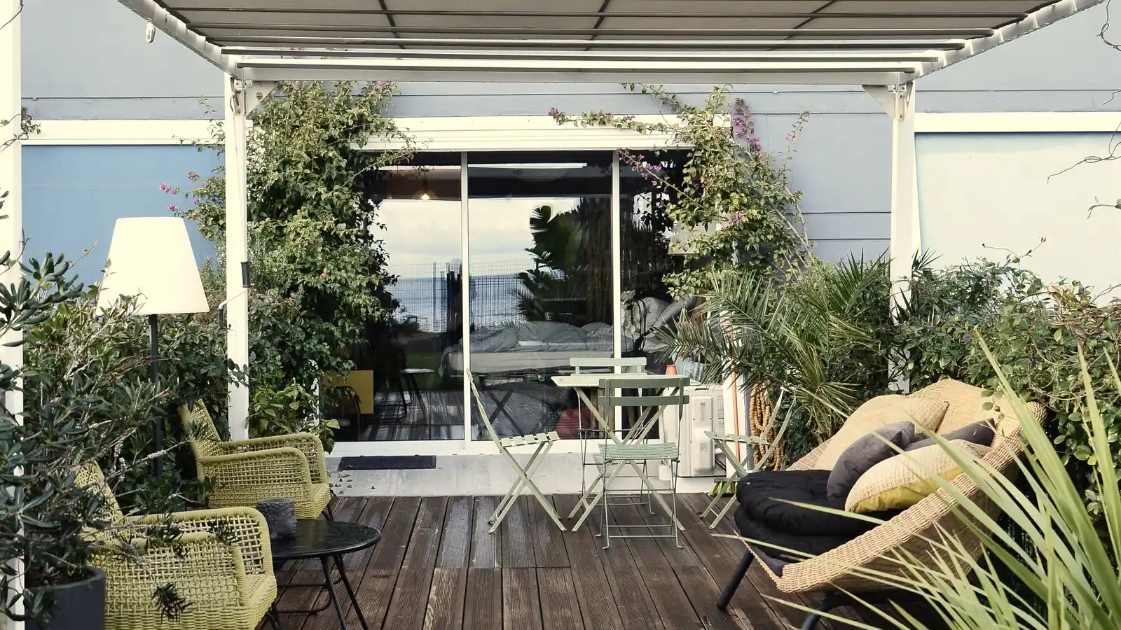 A retractable fabric awning extended over a residential patio deck