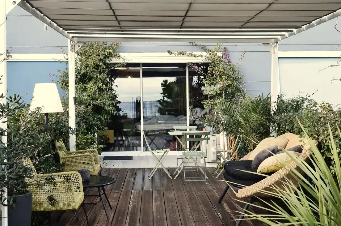 A retractable fabric awning extended over a residential patio deck