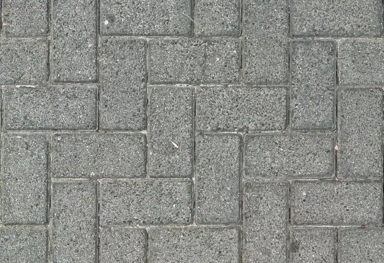 Gray concrete pavers arranged in a basketweave pattern on a patio