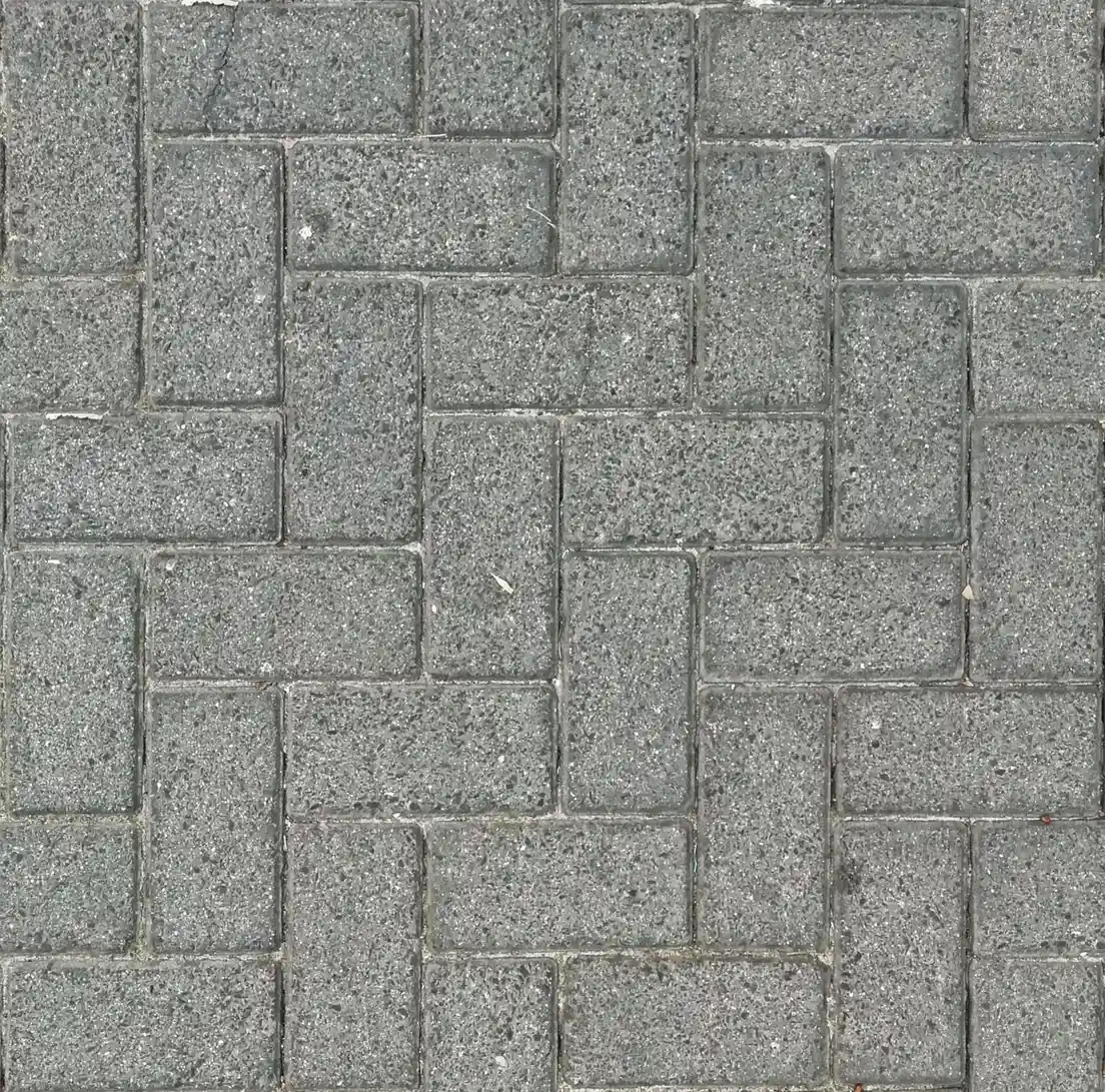 Gray concrete pavers arranged in a basketweave pattern on a patio