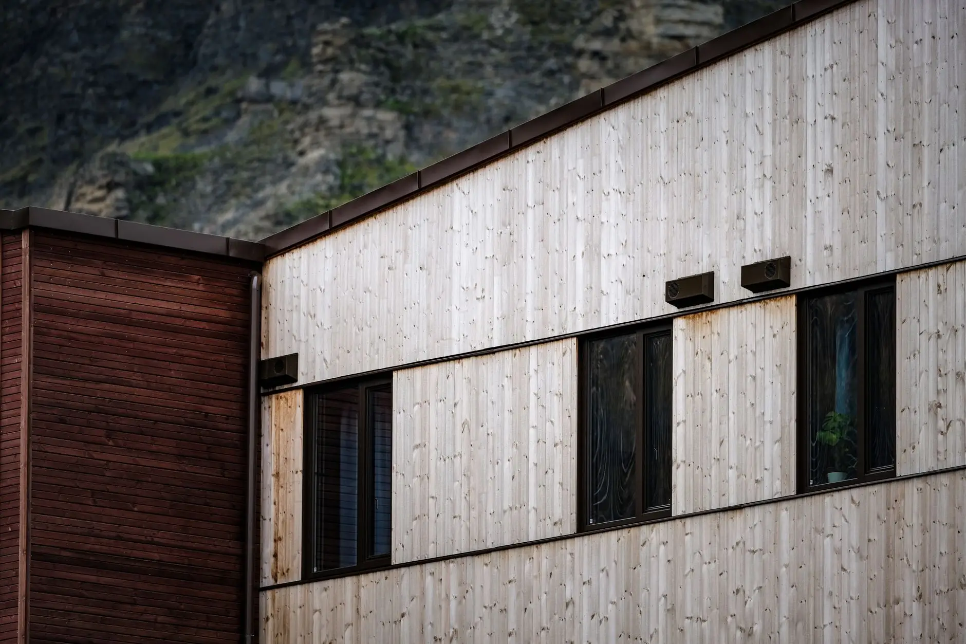 Vertical board-and-batten style wood siding next to horizontal siding on a modern farmhouse exterior