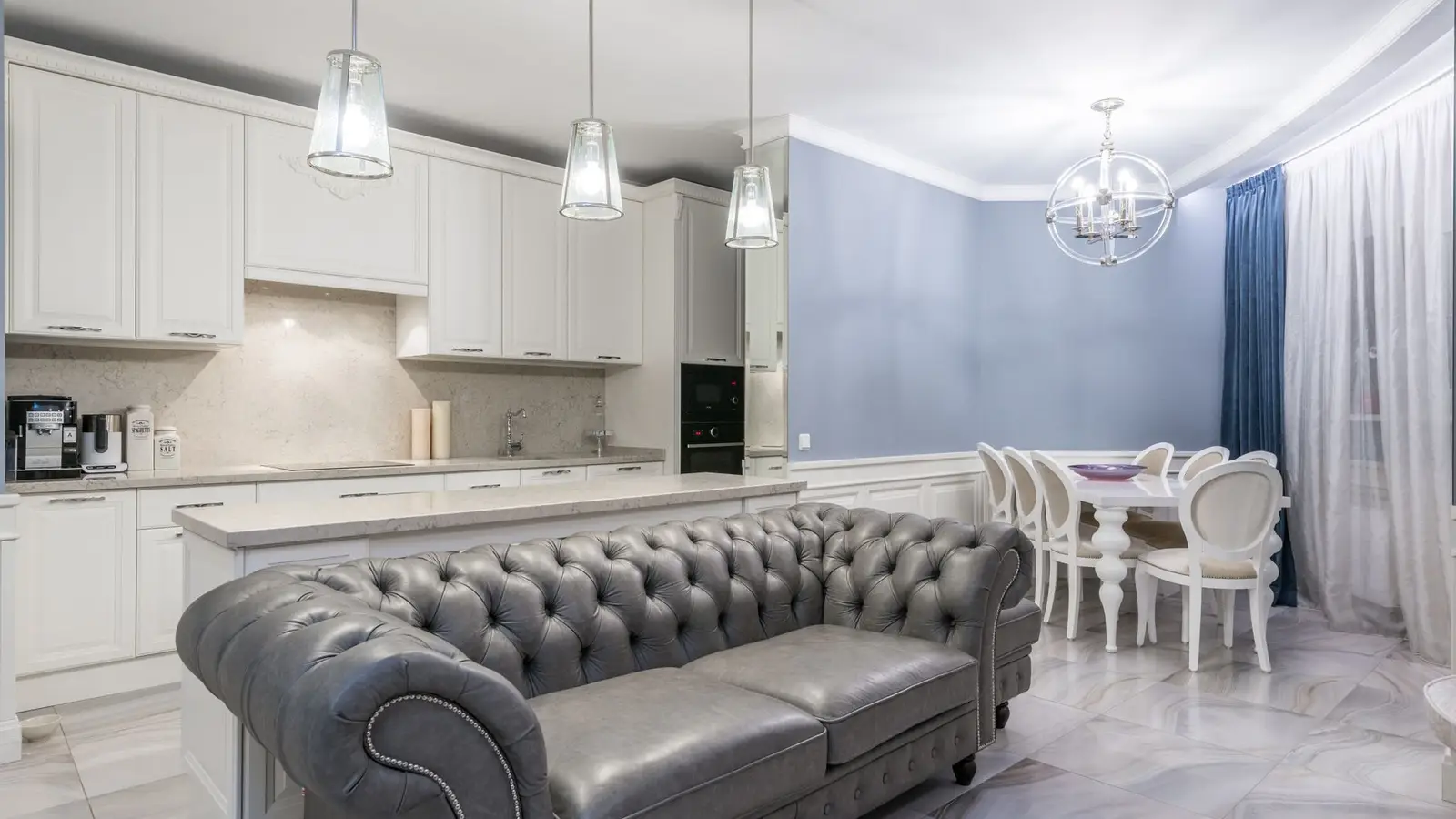 A small apartment's combined kitchen and living room styled on a modest budget with consistent finishes