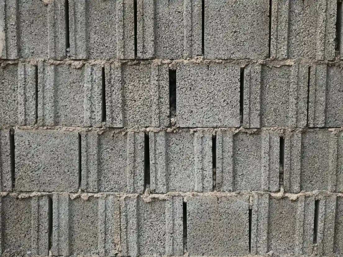 Close-up of gray cinder blocks stacked for a DIY backyard bbq area island