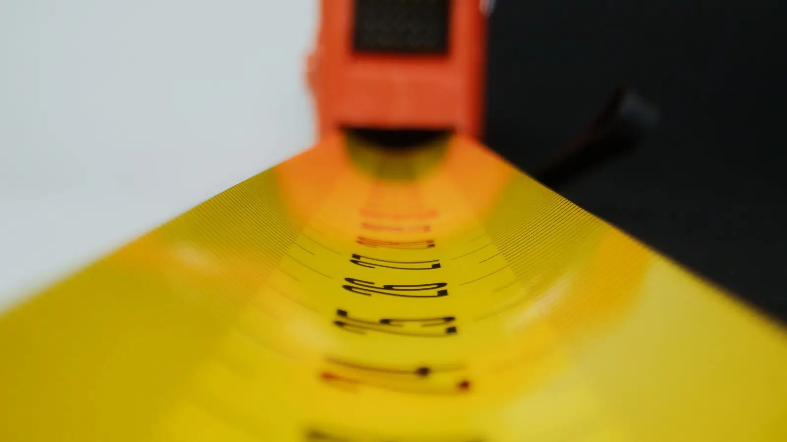 A tape measure being used to plan a small primary bedroom layout