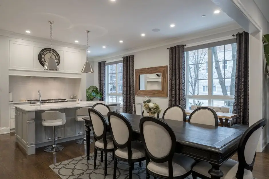 A dining area viewed through a pass-through opening from a closed kitchen
