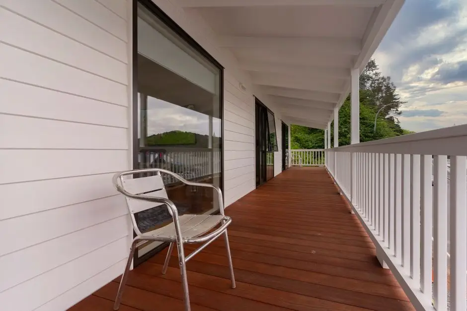 An elevated covered wood deck with railing, showing how a deck differs from a porch or patio