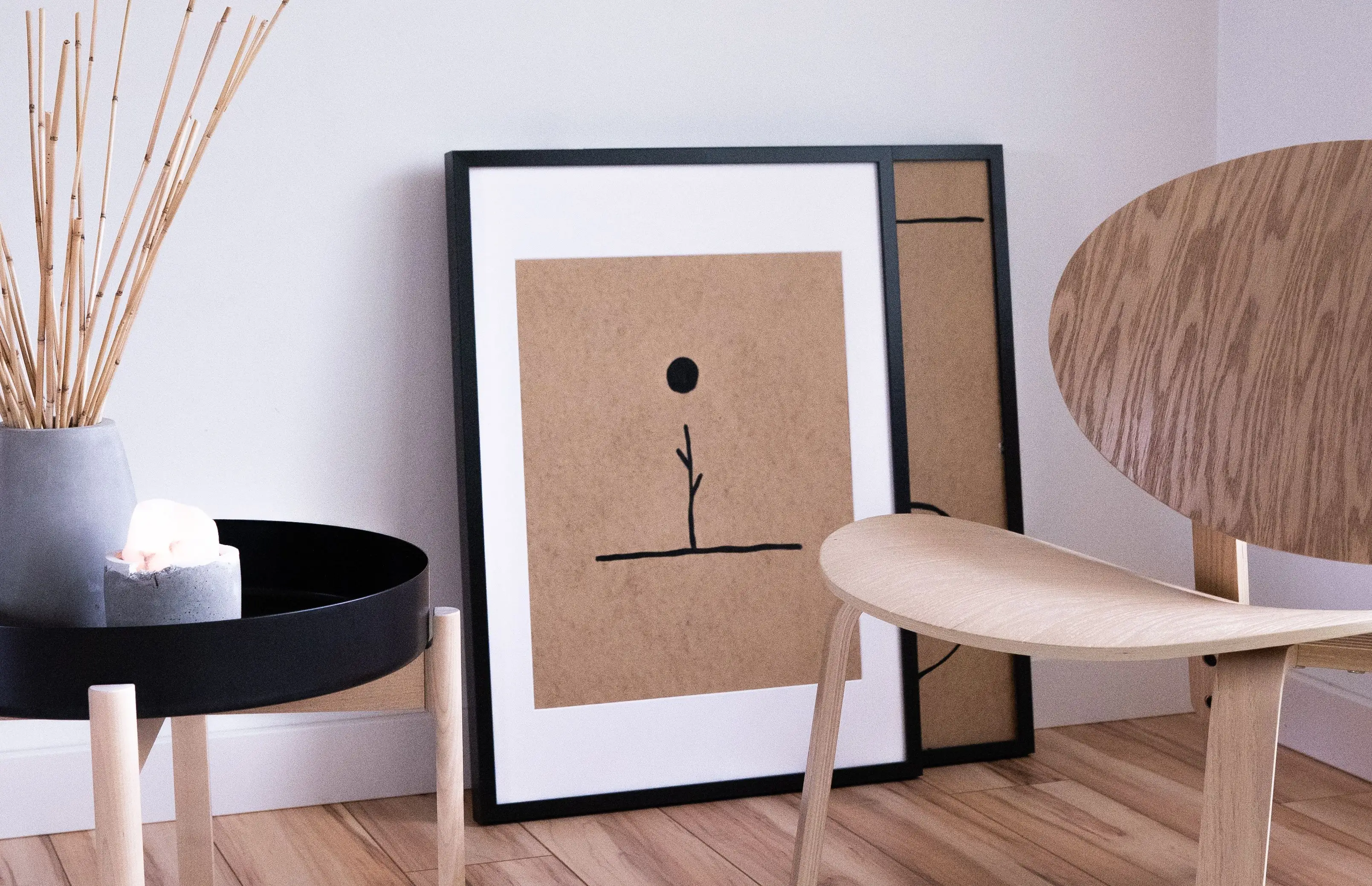 A serene Japandi living room with minimalist wooden furniture and negative space on the floor