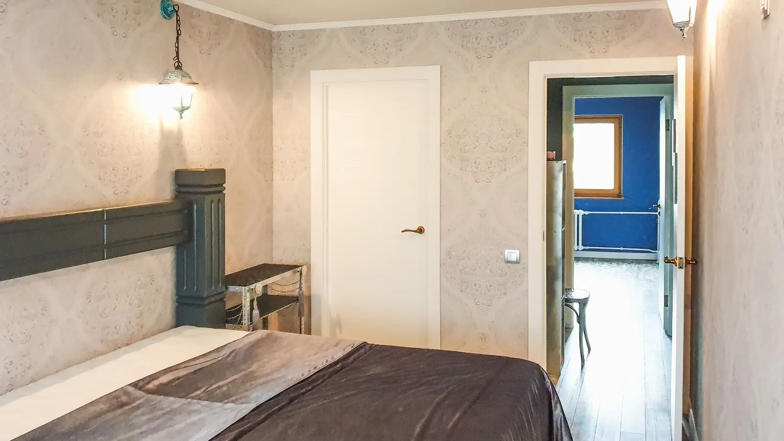 A primary bedroom door swing left clear of furniture near an ensuite bathroom