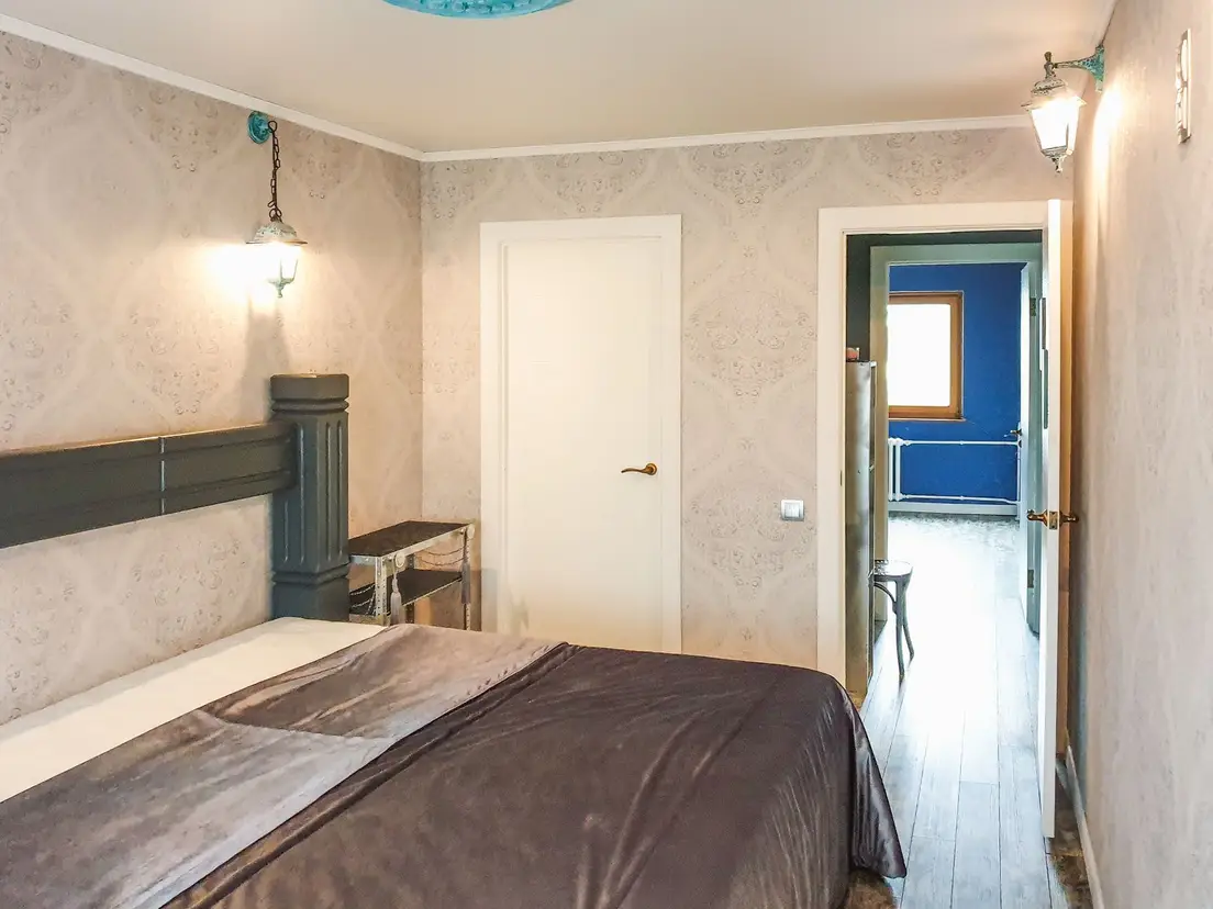 A primary bedroom door swing left clear of furniture near an ensuite bathroom