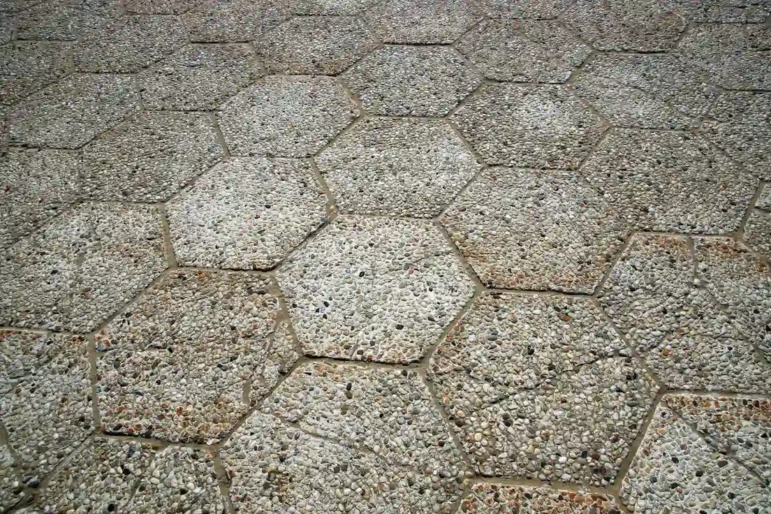 Decorative hexagonal exposed-aggregate concrete pavers on a patio