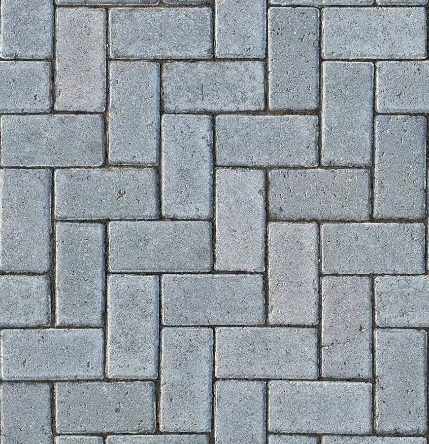 Close-up of gray concrete pavers laid in a herringbone pattern