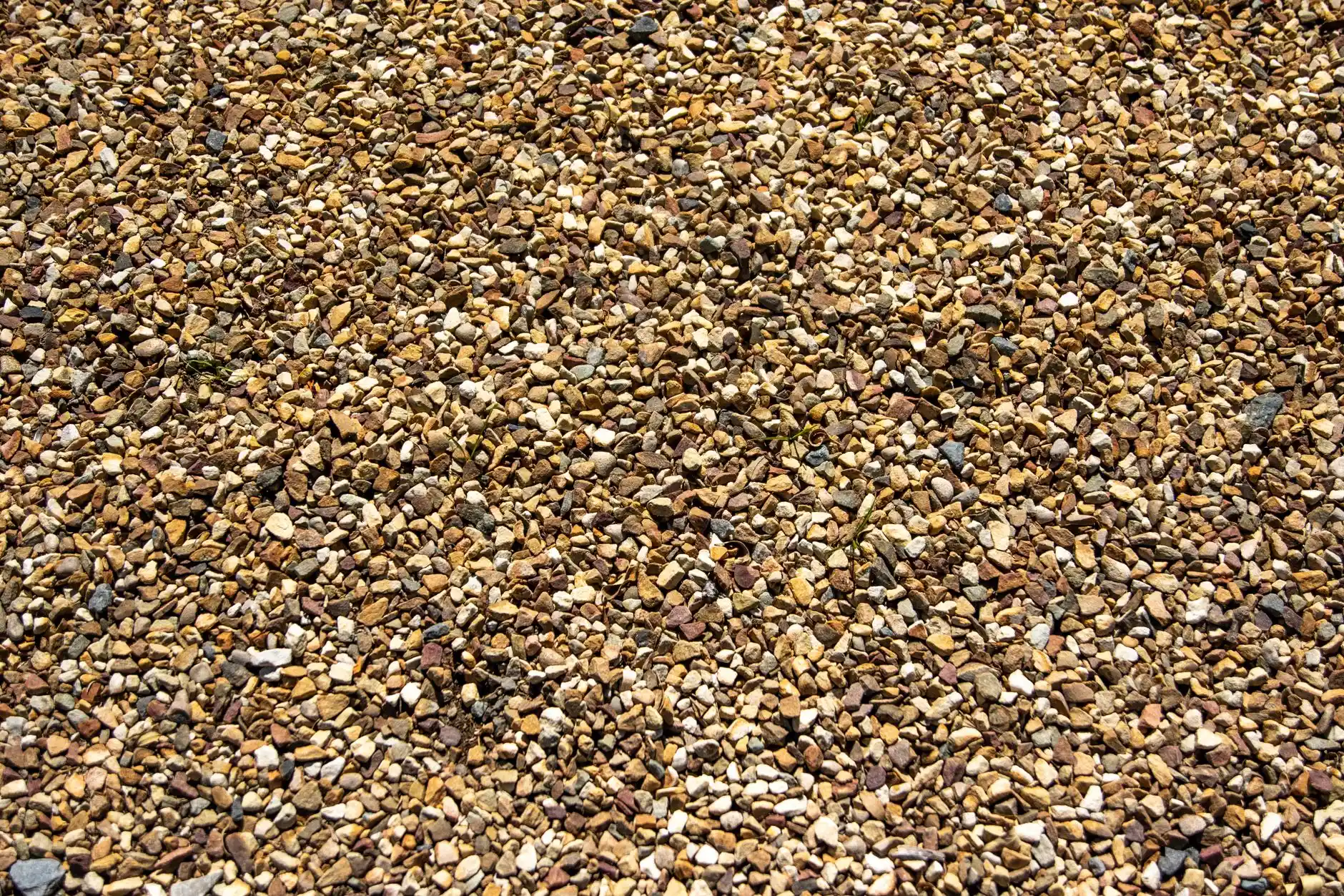 A close-up view of loose crushed gravel material in bulk