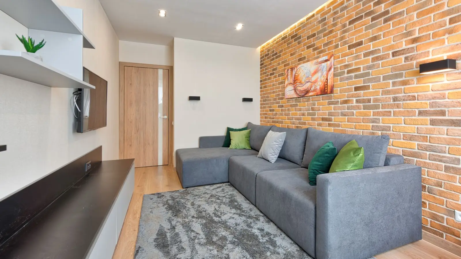 An L-shaped gray sectional sofa fitted into the corner of a small living room