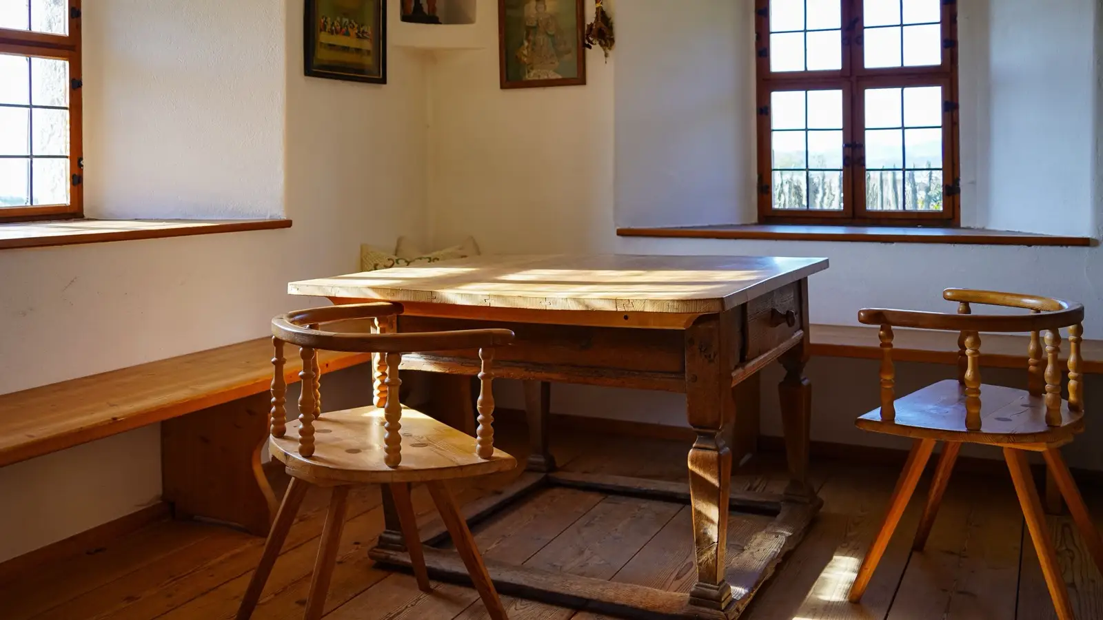 A rustic solid wood farmhouse table and chairs showing raw, natural wood grain and texture