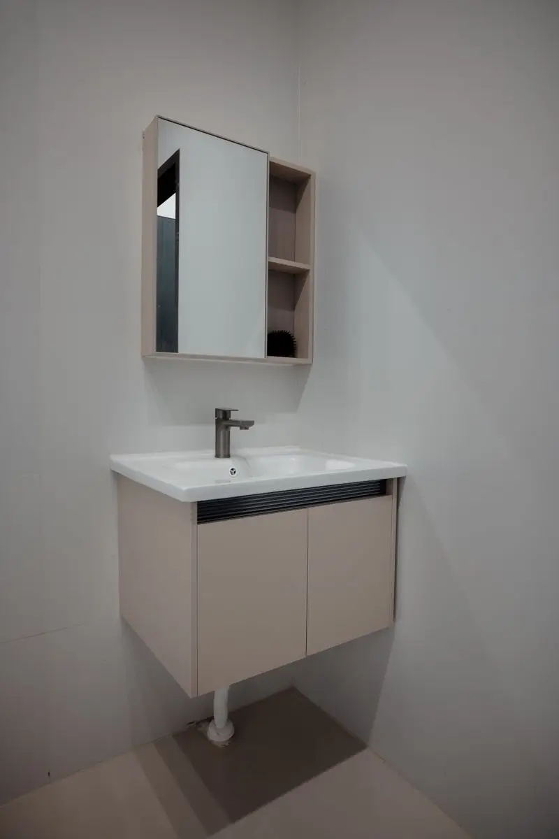 A floating bathroom vanity with a mirrored medicine cabinet and open shelving above it