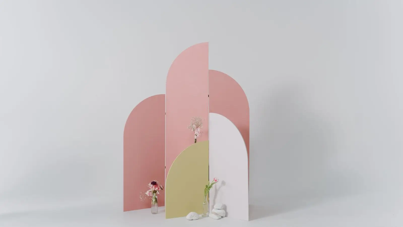 A modular arch-shaped panel wall system, illustrating a pressure-fit temporary wall kit assembly