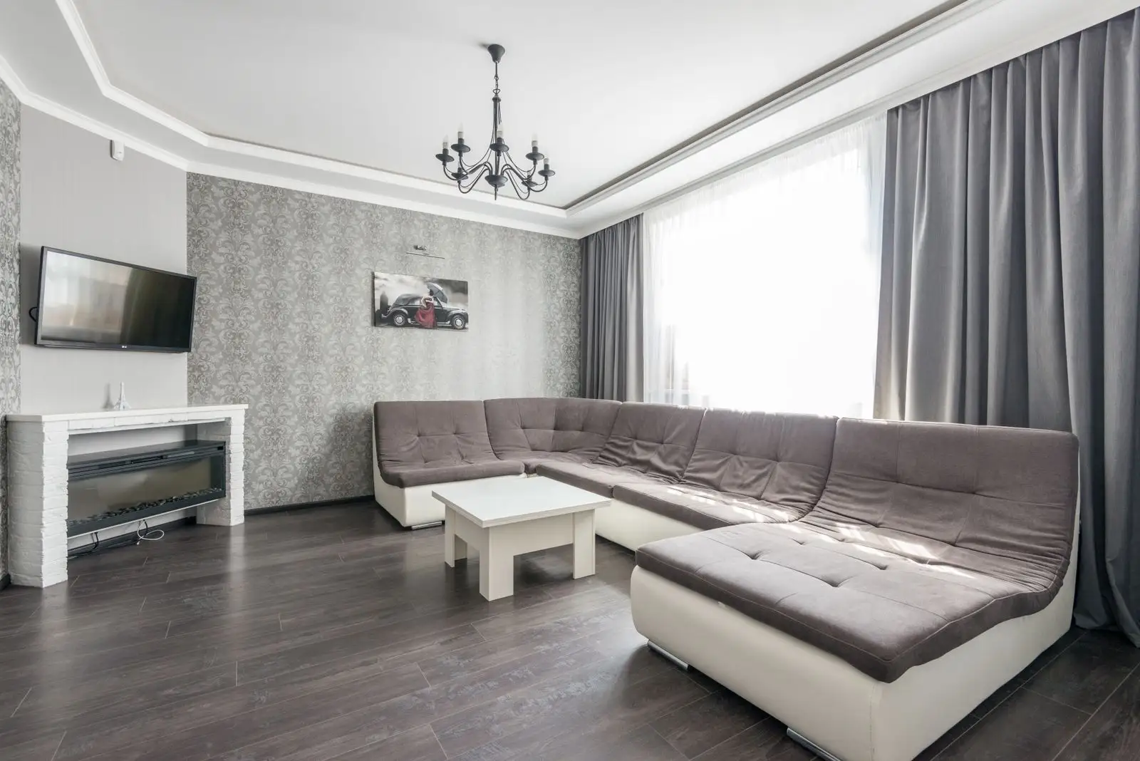 A modular sectional sofa arranged along two walls in a small apartment, multifunctional furniture that reconfigures for a move