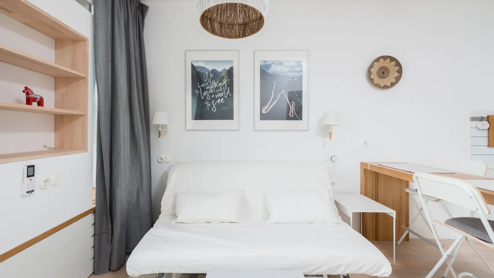 A small apartment living room with a wooden sofa bed doubling as multifunctional furniture