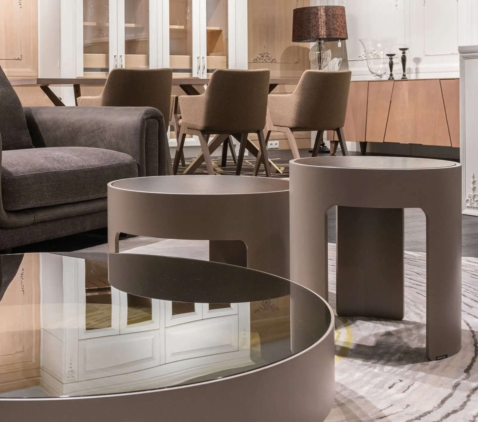 A pair of round nesting tables beside a sofa in a small apartment, multifunctional furniture that tucks away to one footprint
