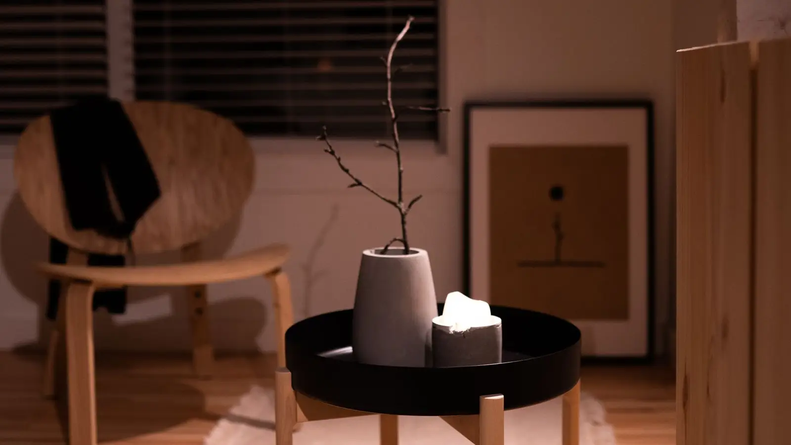 A warm japandi seating area with cane-back chairs, a plaster side table, and dried botanicals against neutral curtains