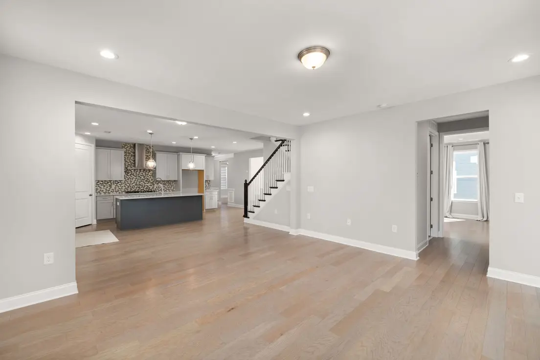A small home with the same warm flooring and wall color carried from the kitchen through to the living room
