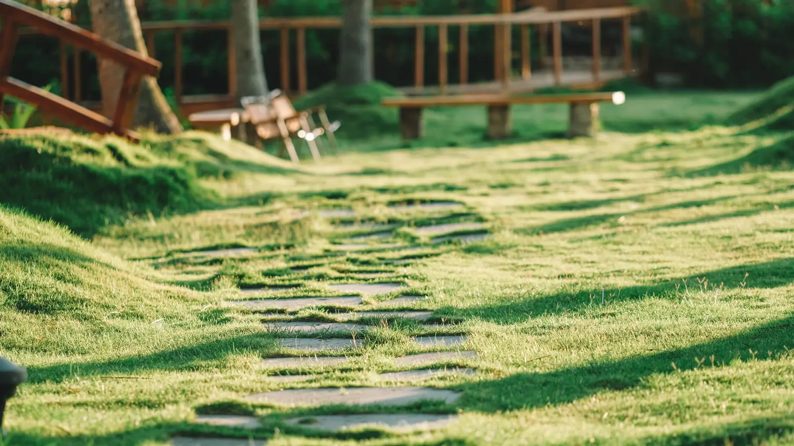 A stepping-stone paver path leading across a grass lawn