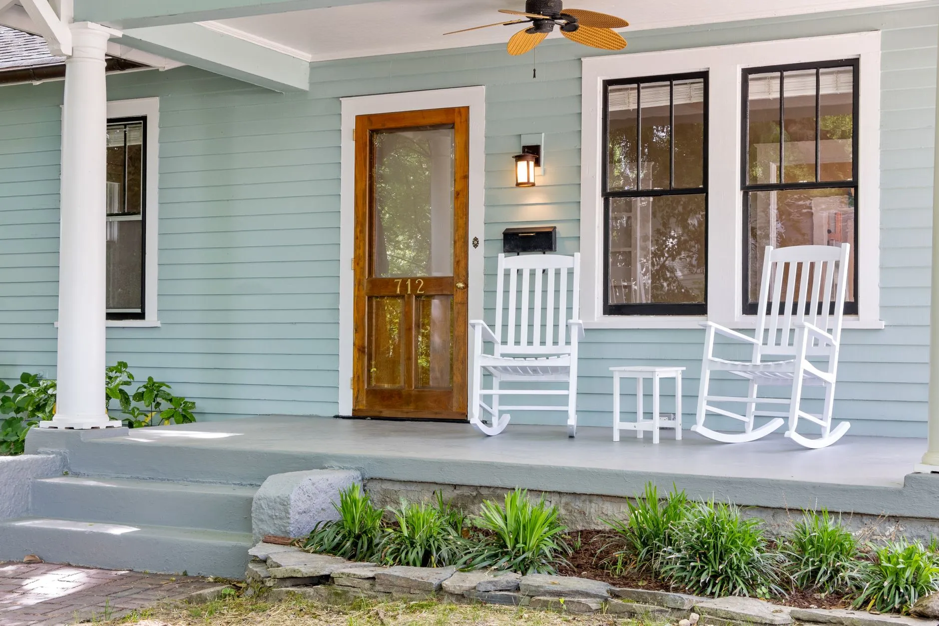 Square white porch columns and board-and-batten siding on a modern farmhouse exterior