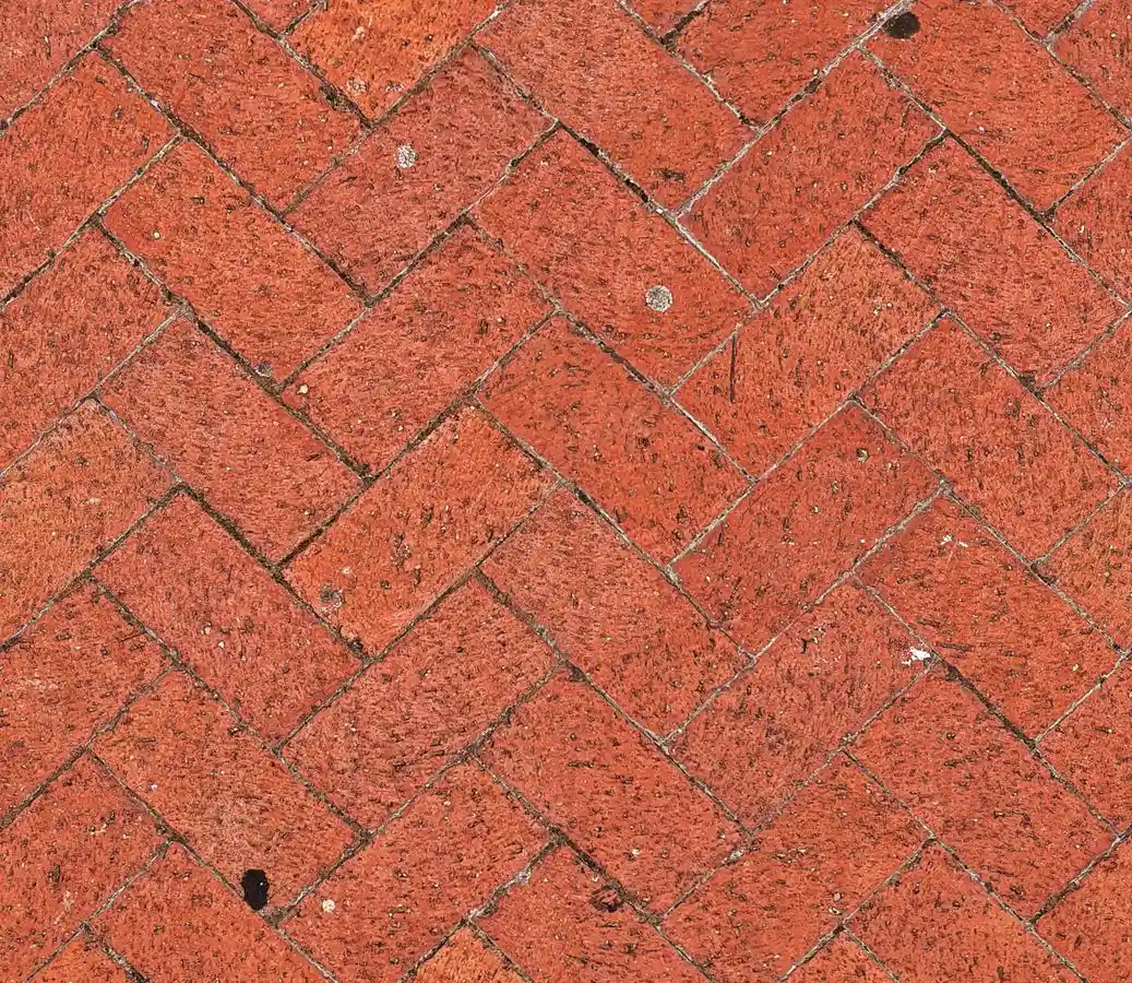 Reclaimed red brick pavers laid in a herringbone pattern