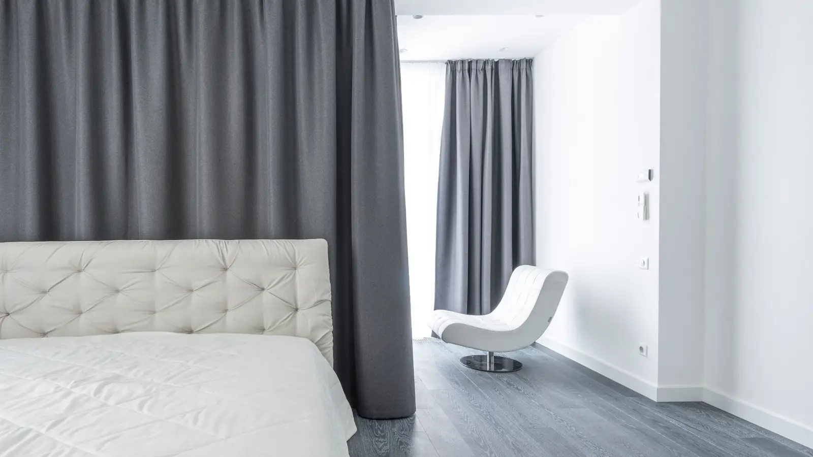 A sleeping nook in a small apartment curtained off from the rest of the studio for privacy