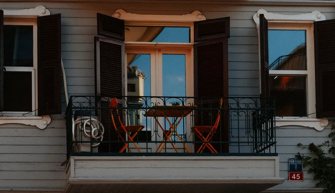 Small balcony with bistro table set up as a compact bbq area idea