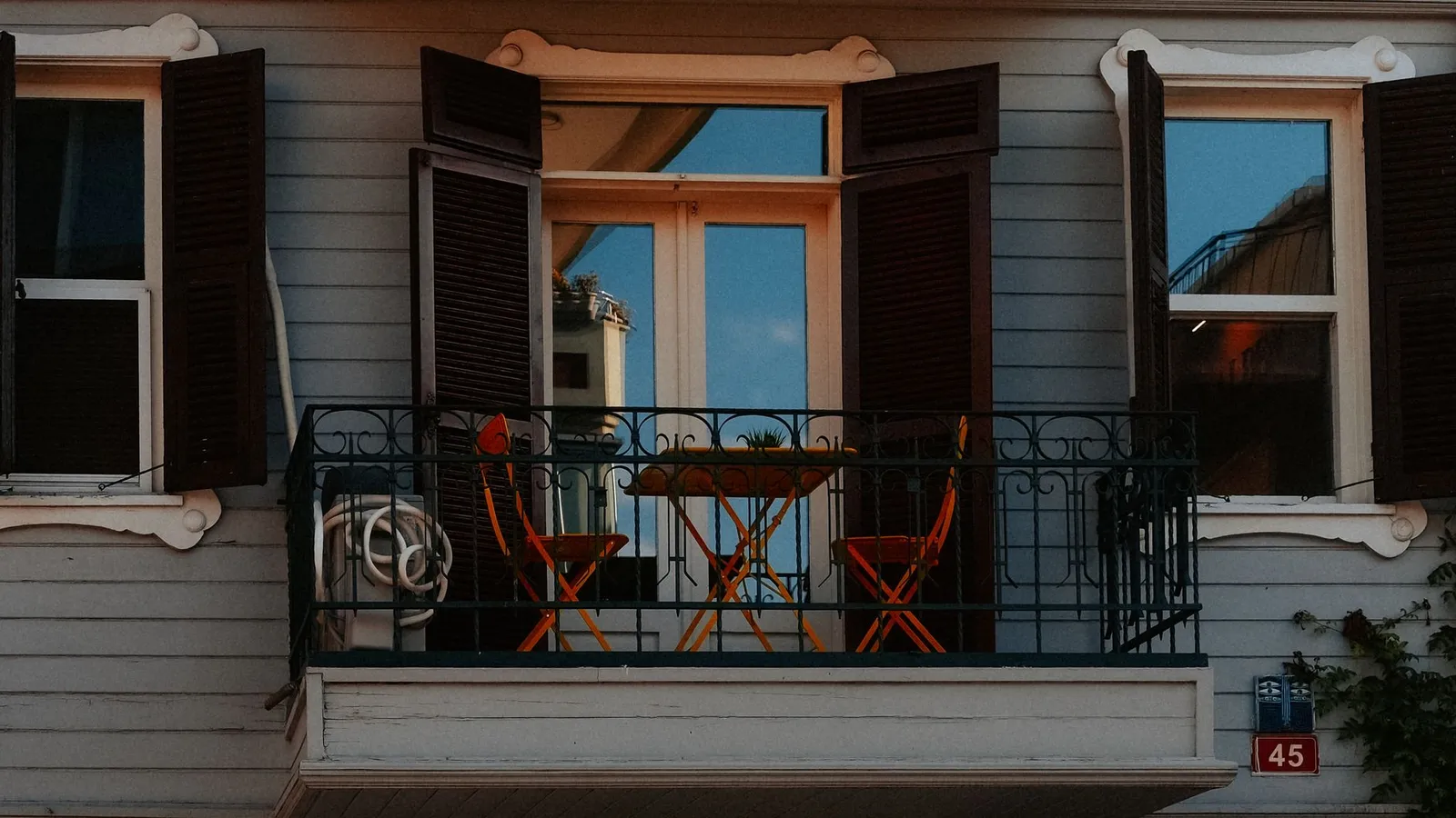 Small balcony with bistro table set up as a compact bbq area idea
