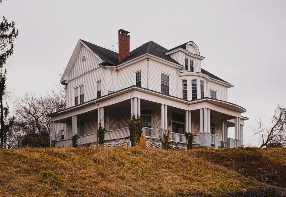 A historic wraparound porch showing the roof, columns, and foundation attachment that define a porch