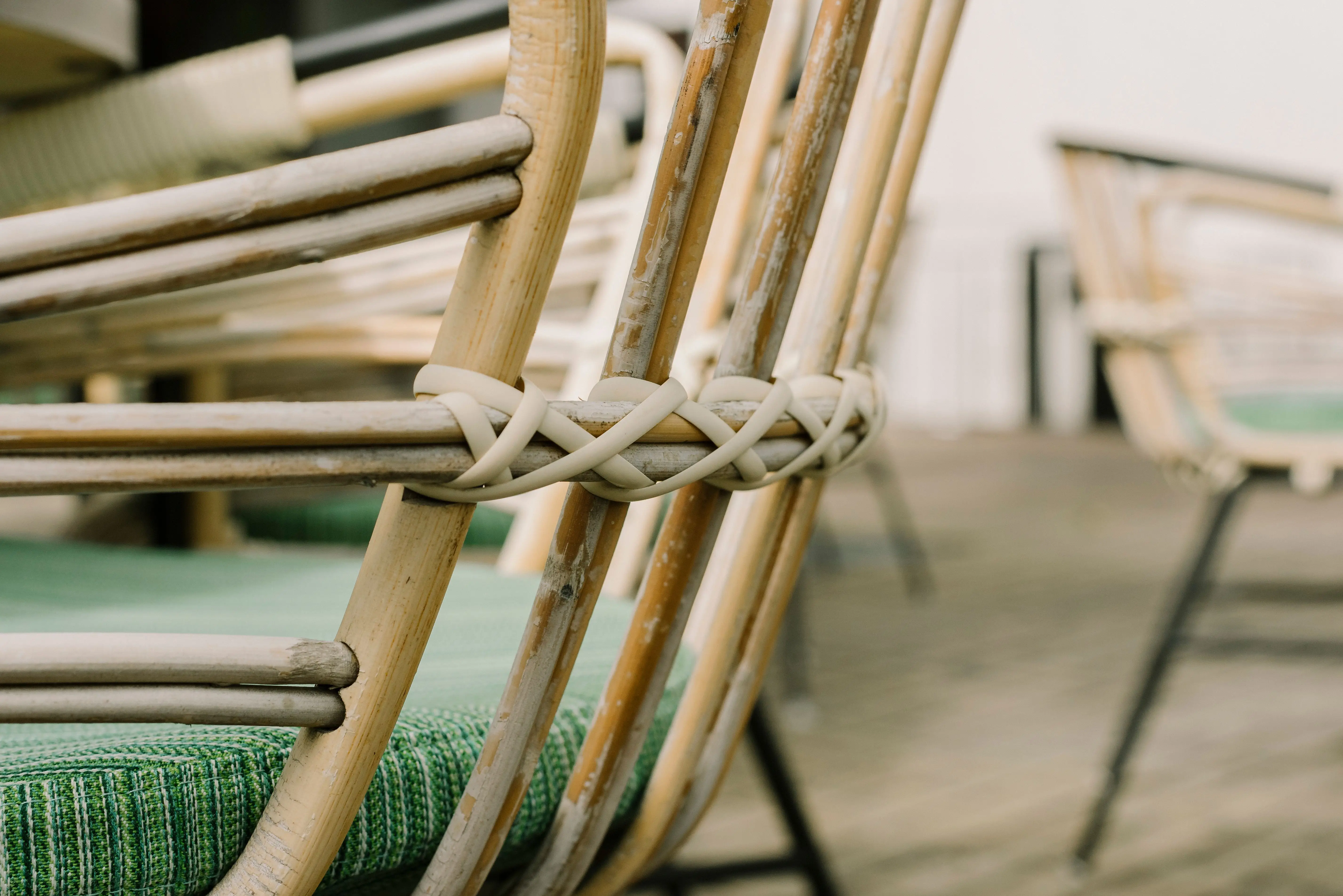 A close-up of a wickered rattan chair showing natural woven texture in a living room