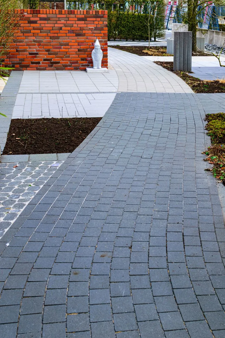 A curved brick paver walkway with a defined brick border edging the path