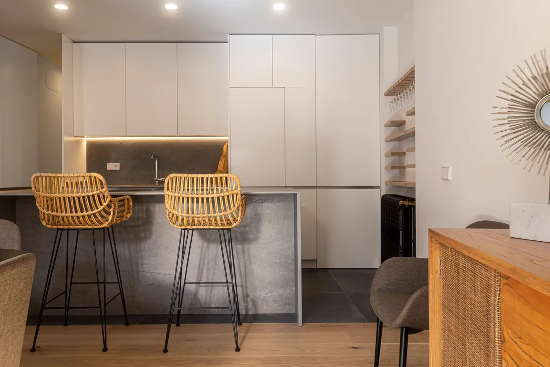 Woven rattan bar stools at a modern farmhouse kitchen island