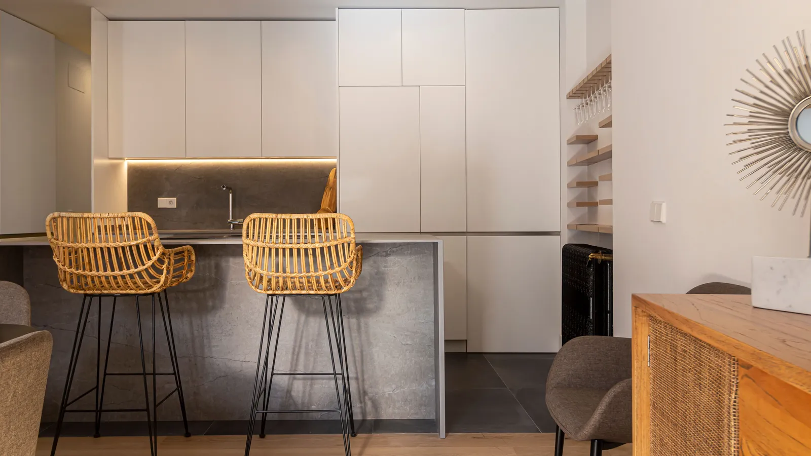 Woven rattan bar stools at a modern farmhouse kitchen island